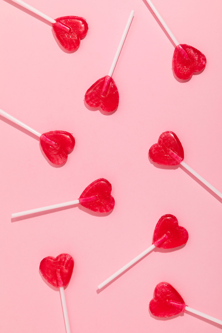 Heart-Shaped Lollipops on Pink Background